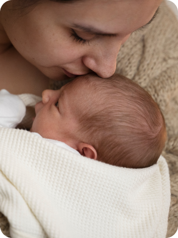 a woman kissing a baby